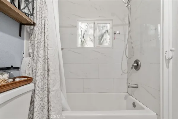 a bathroom with a bathtub and shower