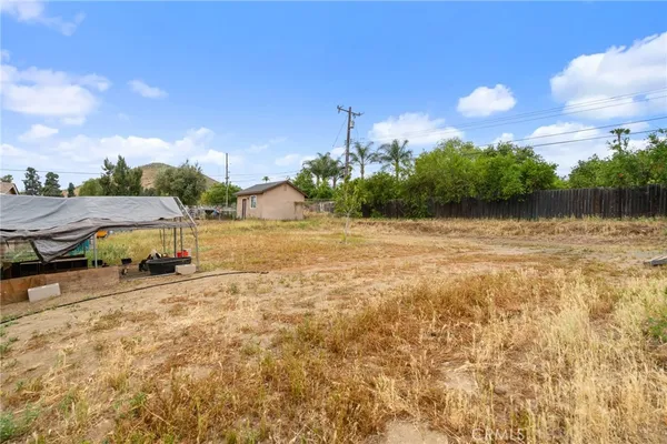 a backyard of a house with table and chairs