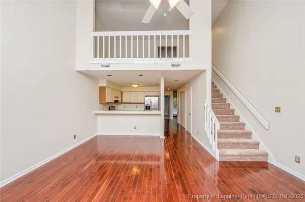 a view of a room with wooden floor and staircase