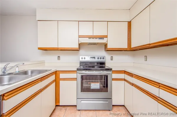a kitchen with stainless steel appliances granite countertop a sink and a stove