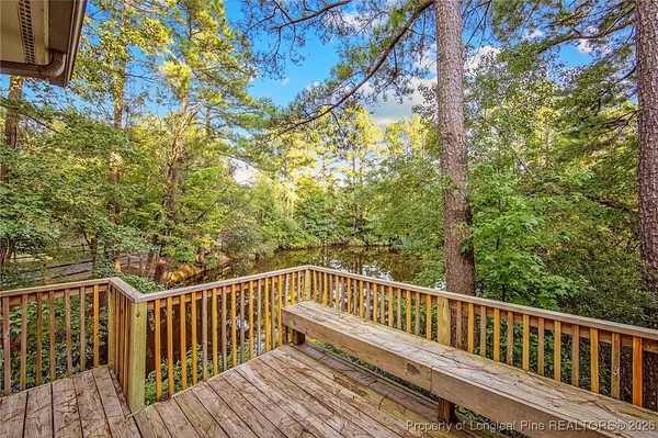 a view of balcony with wooden floor and fence