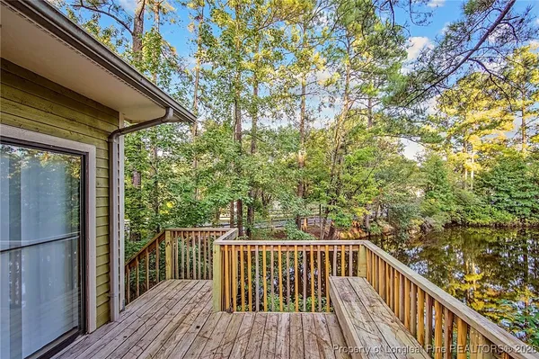 a view of balcony with wooden floor and fence