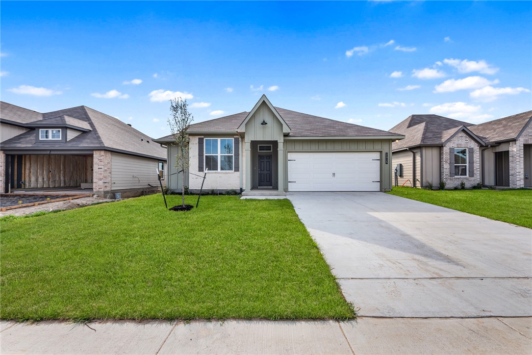 2415 Rooke Road Bryan, TX 77807 - Photo 1 of 36 a front view of a house with a garden and yard