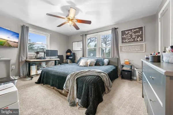 a bed room with a bed and a large window