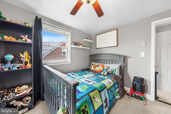 a bedroom with a bed and a baby crib