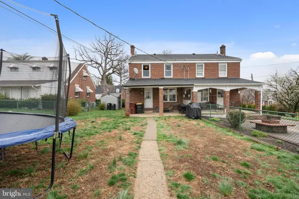 a front view of a house with a yard table and chairs