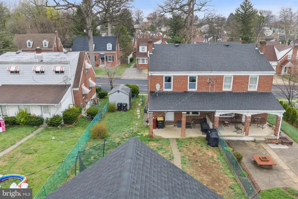 a aerial view of a house with a yard table and chairs