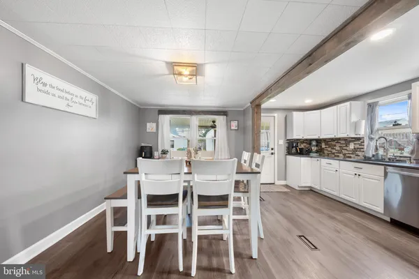 a view of a dining room with furniture and wooden floor