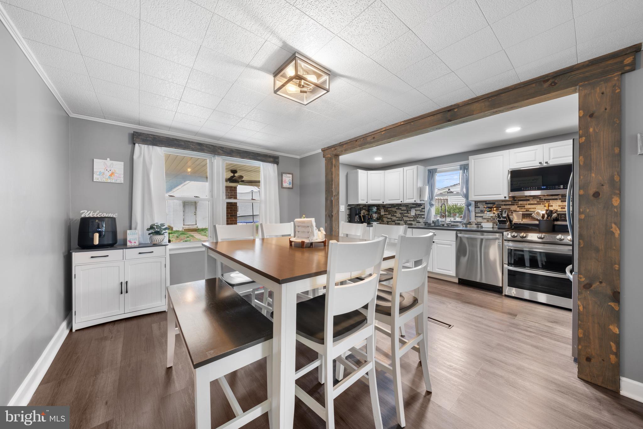 240 5th Street Whitehall, PA 18052 - Photo 7 of 43 a kitchen with a dining table chairs stainless steel appliances and cabinets