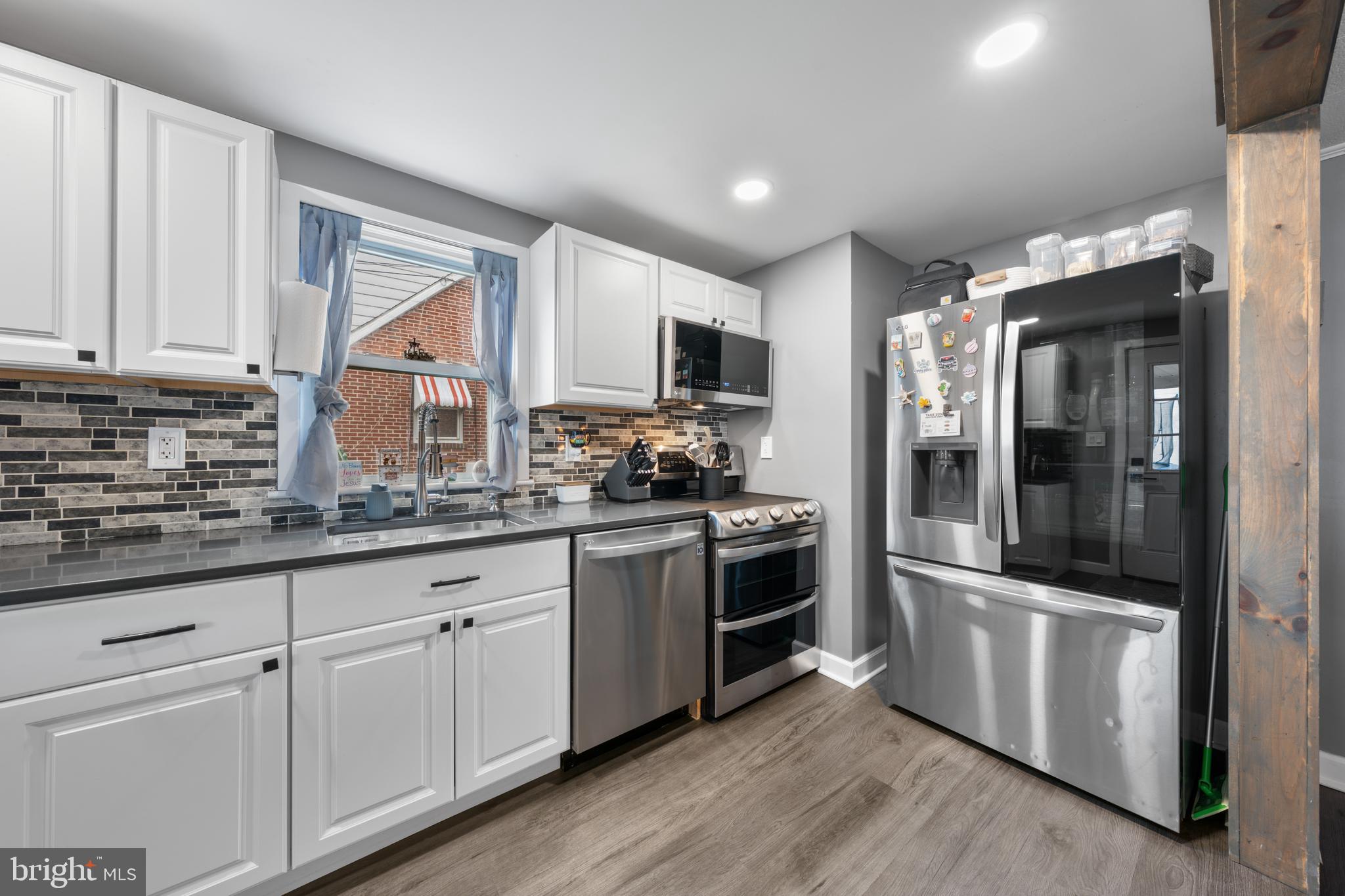 240 5th Street Whitehall, PA 18052 - Photo 9 of 43 a kitchen with granite countertop white cabinets and stainless steel appliances