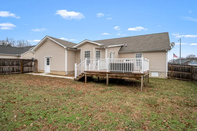 a view of a house with a big yard and large trees