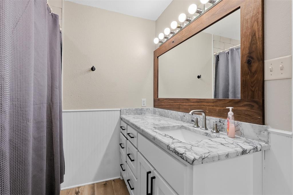 397 Rs County Road 4452 Point, TX 75472 - Photo 13 of 34 a bathroom with a sink vanity and a mirror