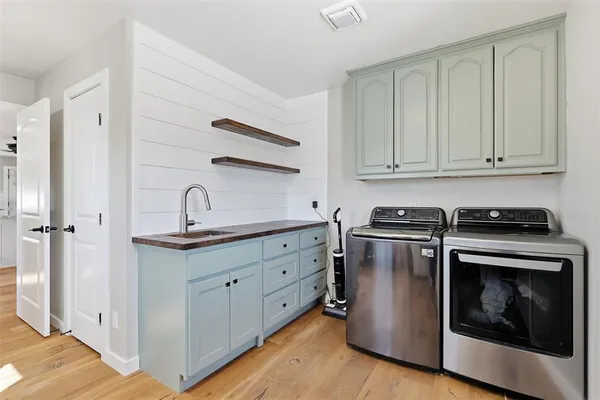 a kitchen with granite countertop white cabinets and a stove with wooden floors