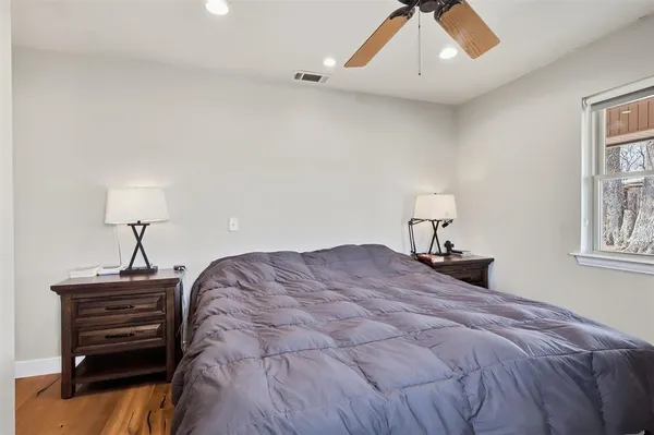 a bedroom with a bed and a chandelier