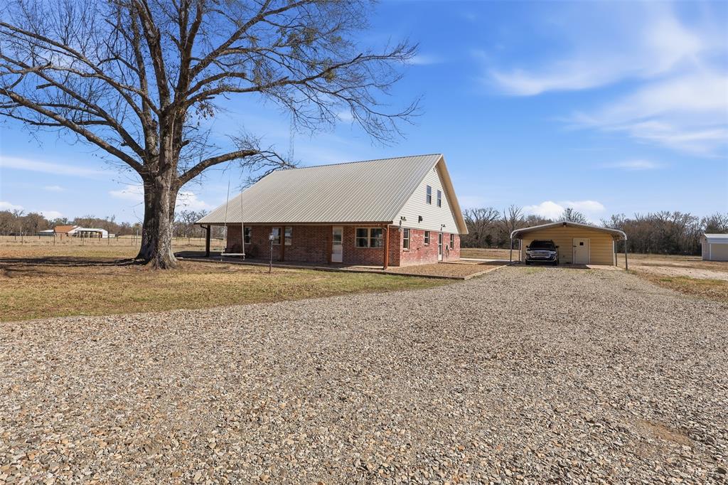 397 Rs County Road 4452 Point, TX 75472 - Photo 2 of 34 Front of home with gravel driveway and carport