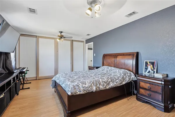 a bedroom with a bed and a chandelier
