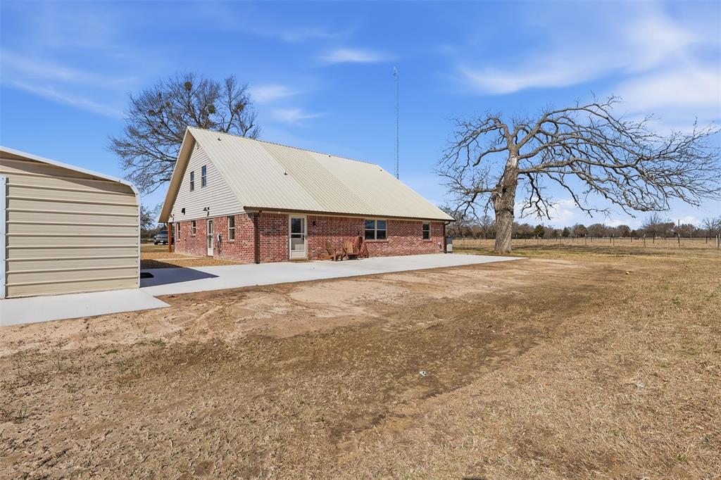 397 Rs County Road 4452 Point, TX 75472 - Photo 31 of 34 a view of a house with a yard and garage