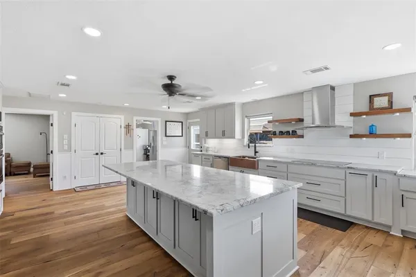a large kitchen with kitchen island a sink and a stove