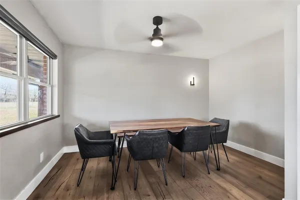 a view of a dining room with furniture and wooden floor