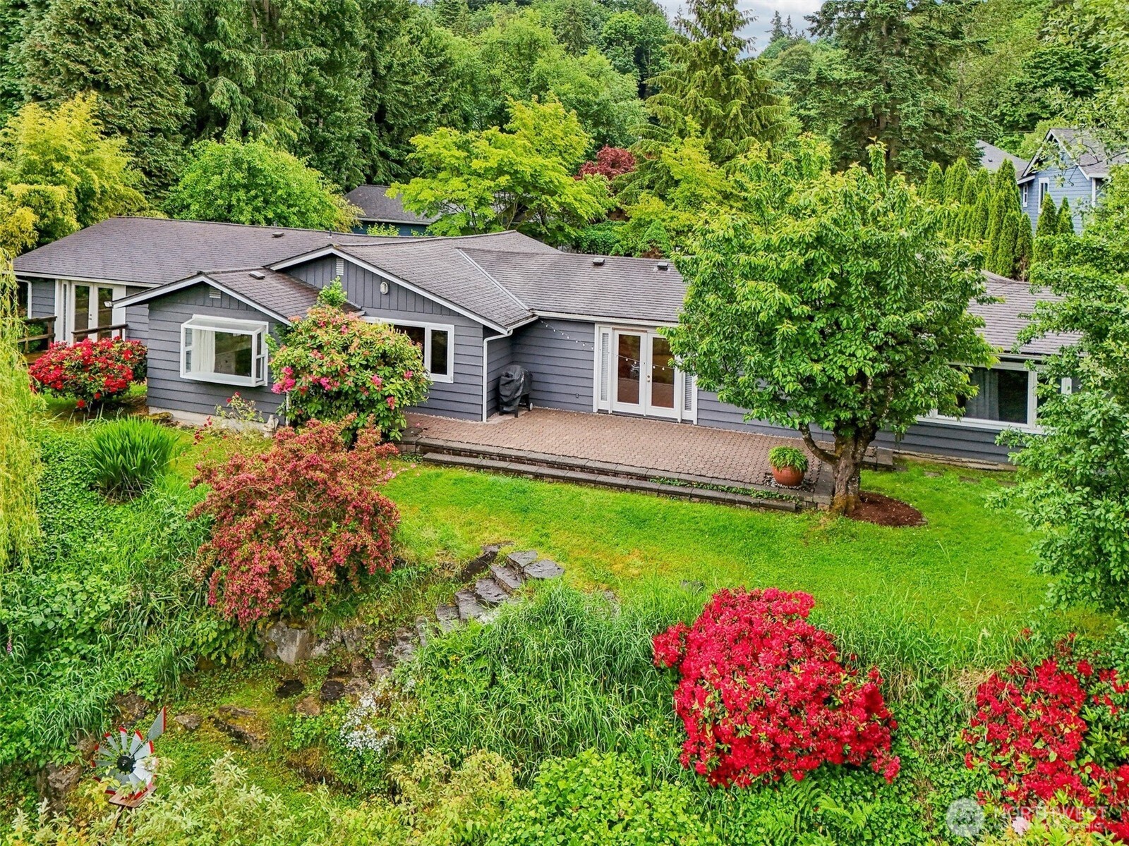 11112 East Riverside Drive Bothell, WA 98011 - Photo 6 of 35 a front view of a house with a yard and fountain