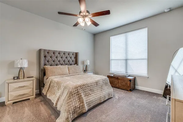 a bedroom with a bed dresser and a window