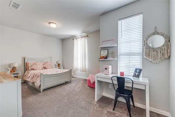 a bedroom with a bed and a table