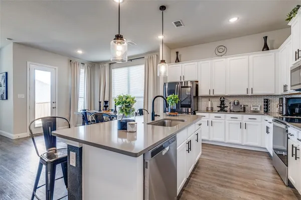 a large white kitchen with lots of counter space and white cabinets