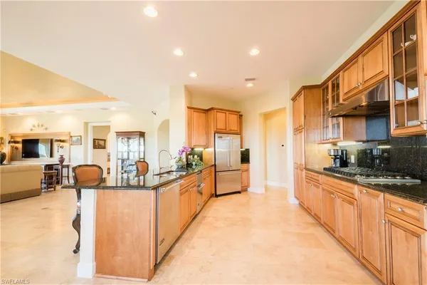 a large kitchen with stainless steel appliances lots of counter space and breakfast area