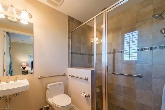 a bathroom with a toilet a sink and shower