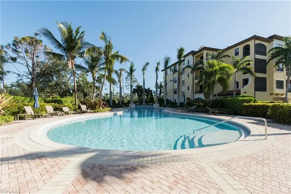 a view of swimming pool with outdoor seating and yard