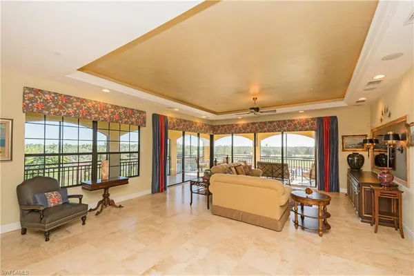 a living room with furniture and a floor to ceiling window