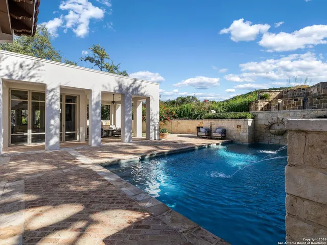 a view of a hallway with wooden floor and windows
