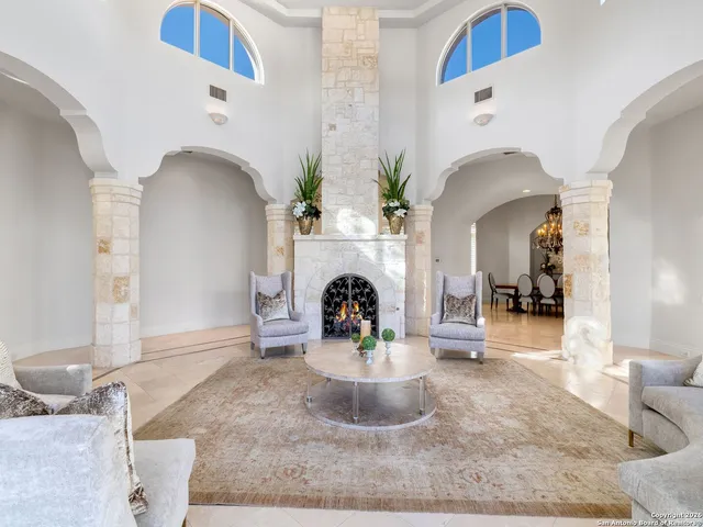 a kitchen with stainless steel appliances kitchen island granite countertop a table and chairs in it