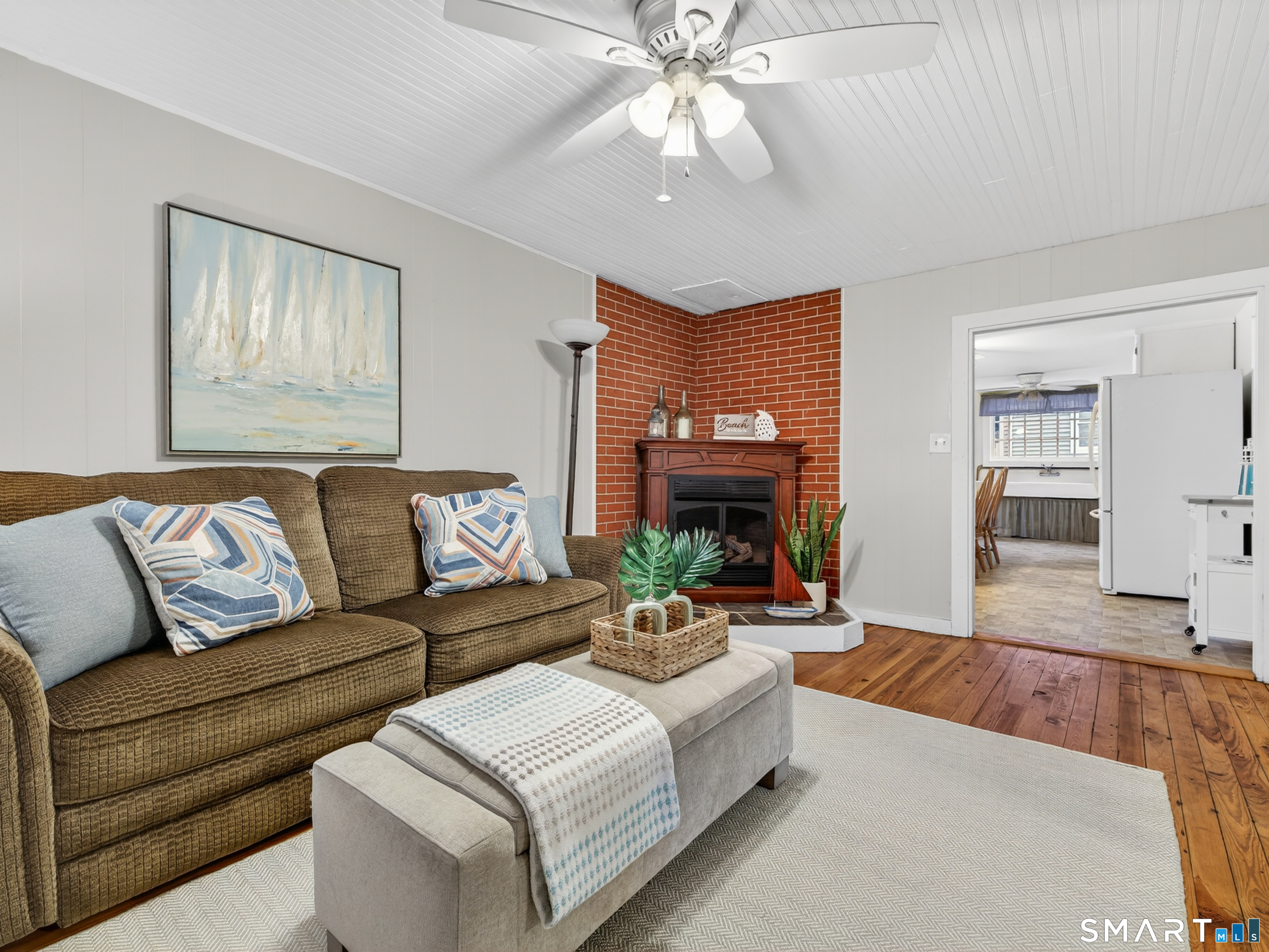 31 Old Colony Road Old Lyme, CT 06371 - Photo 11 of 38 a living room with fireplace furniture and a wooden floor
