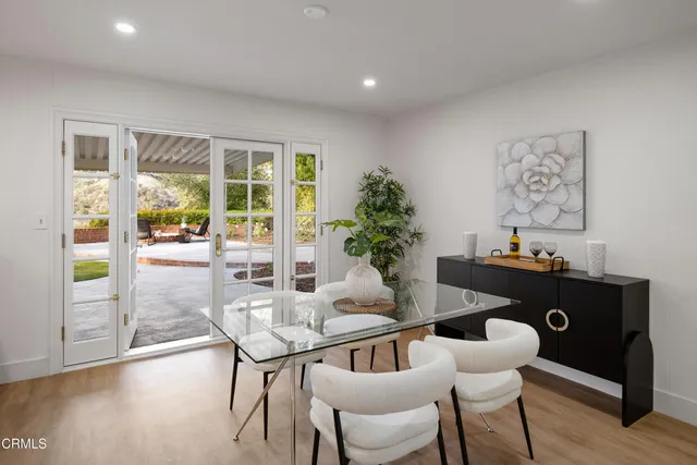 a kitchen with a sink a refrigerator and white cabinets