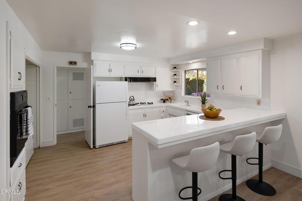 3514 St Elizabeth Road Glendale, CA 91206 - Photo 14 of 75 a kitchen with a sink a refrigerator and white cabinets