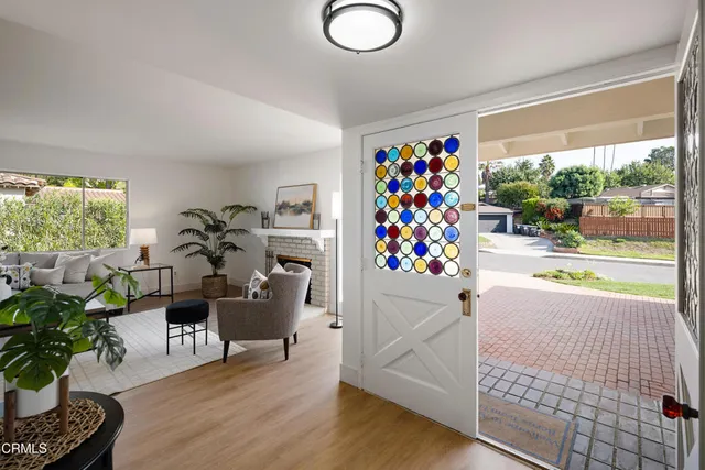 a front view of a house with entryway wooden floor and a table