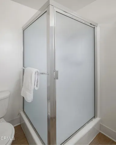 a view of swimming pool with outdoor seating and trees in the background