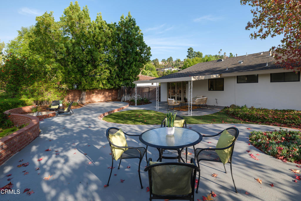 3514 St Elizabeth Road Glendale, CA 91206 - Photo 38 of 75 a view of a patio with table and chairs and potted plants with wooden floor and fence