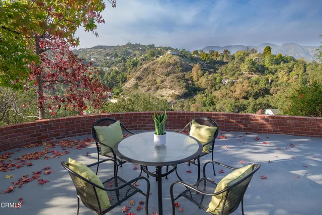 a view of a chairs and table in the patio