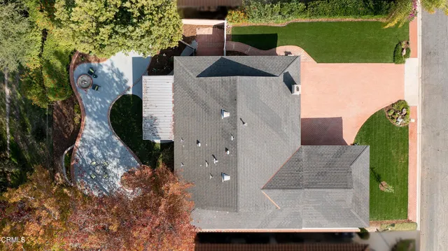 a front view of a house with a garden and yard
