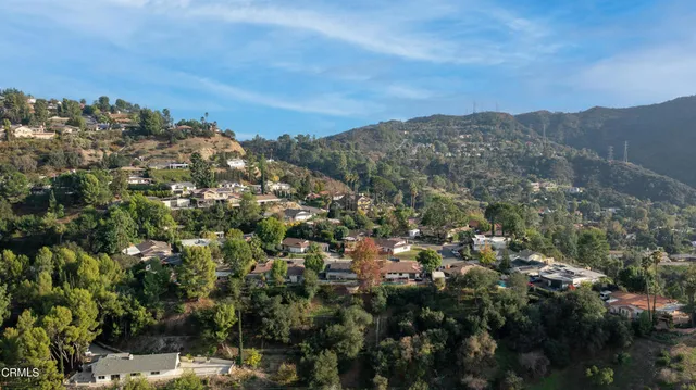 a front view of a house with a garden and yard
