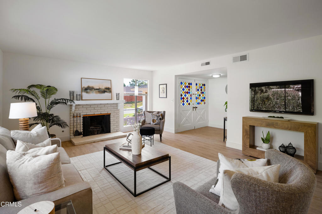 3514 St Elizabeth Road Glendale, CA 91206 - Photo 7 of 75 a living room with furniture a fireplace and a flat screen tv