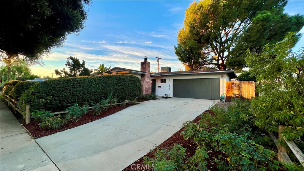 4042 Overland Street Riverside, CA 92503 - Photo 1 of 1 a front view of a house with a yard and garage