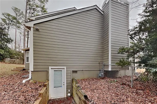 a white house that has a tree in front of it