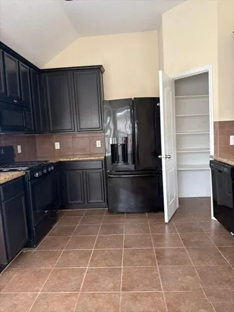 a kitchen with granite countertop a cabinets and steel stainless steel appliances