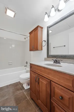 a bathroom with a sink a toilet and bathtub
