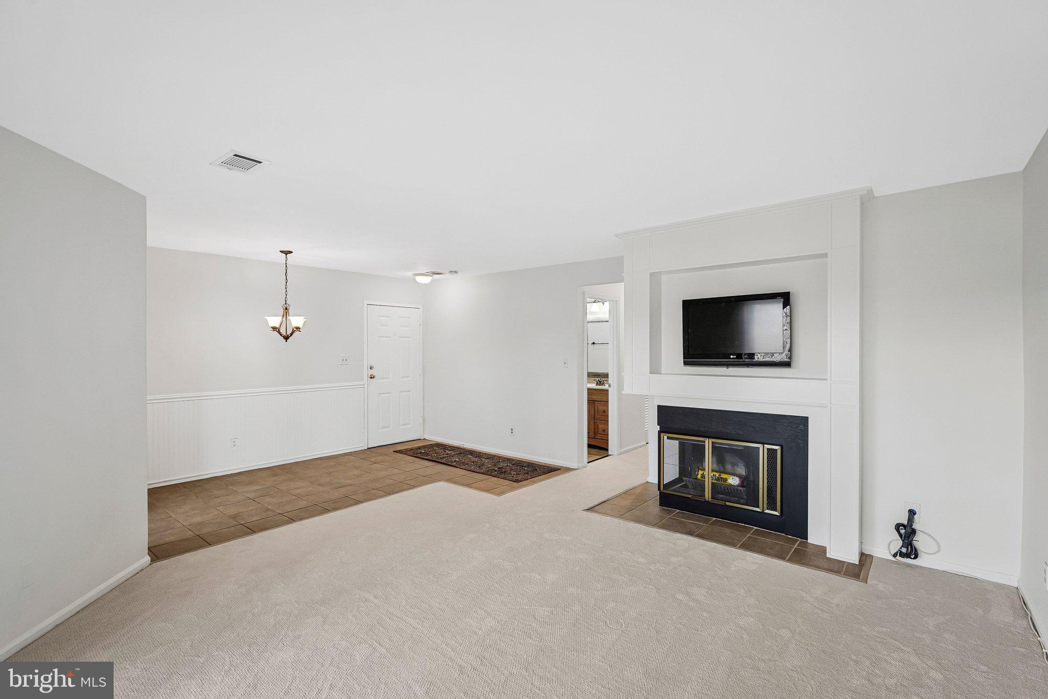 11144 Beaver Trail Court, Unit 11144 Reston, VA 20191 - Photo 19 of 24 Living with woodburing fireplace