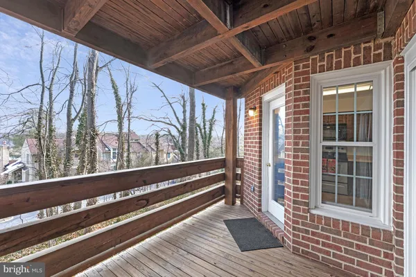 a view of a balcony with wooden floor and stairs