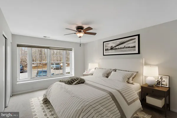 a bedroom with a large bed and a large window